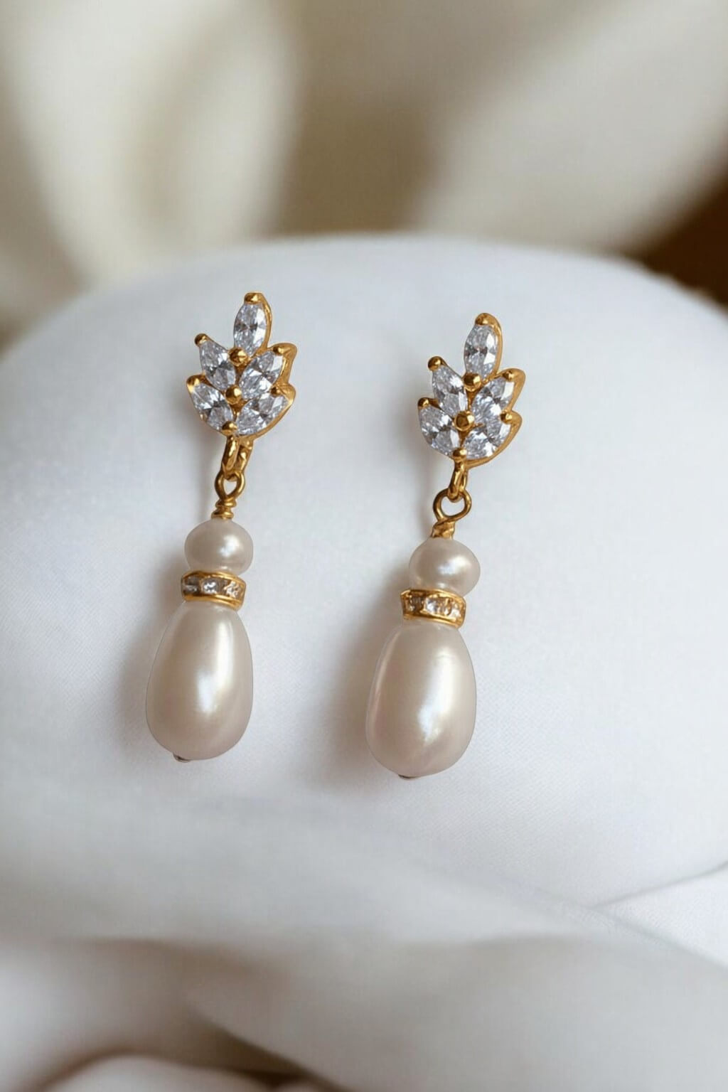 gold-plated freshwater pearl wedding earrings photographed on light matte texture