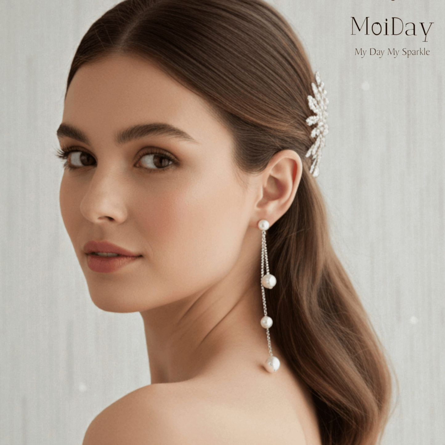 Woman wearing a pearl earring with a soft background, featuring the brand 'MoiDay'.