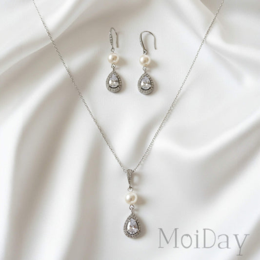 Bridal Jewelry set with necklace and earrings on a white fabric background, featuring the brand 'MoiDay'.
