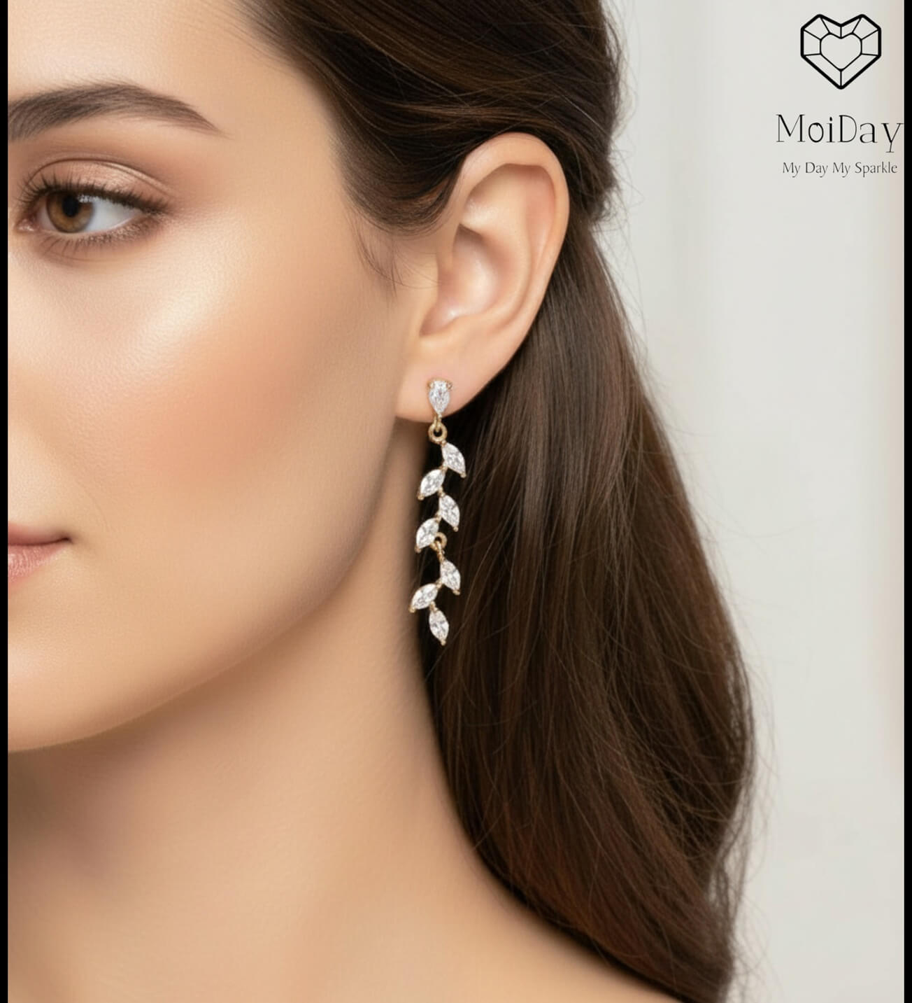 14K gold cascading earrings photographed on model
