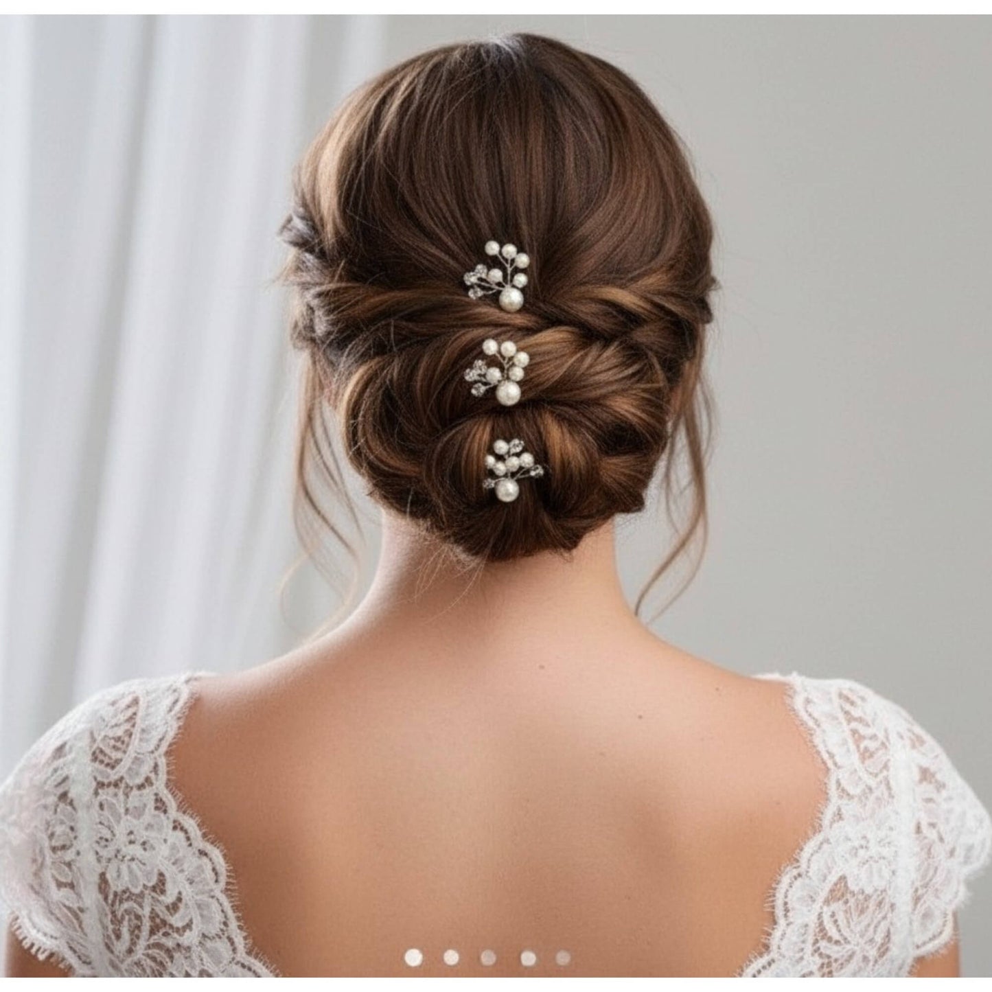 Bride wearing a low bun decorated with gold pearl hair pins for a soft, elegant look.