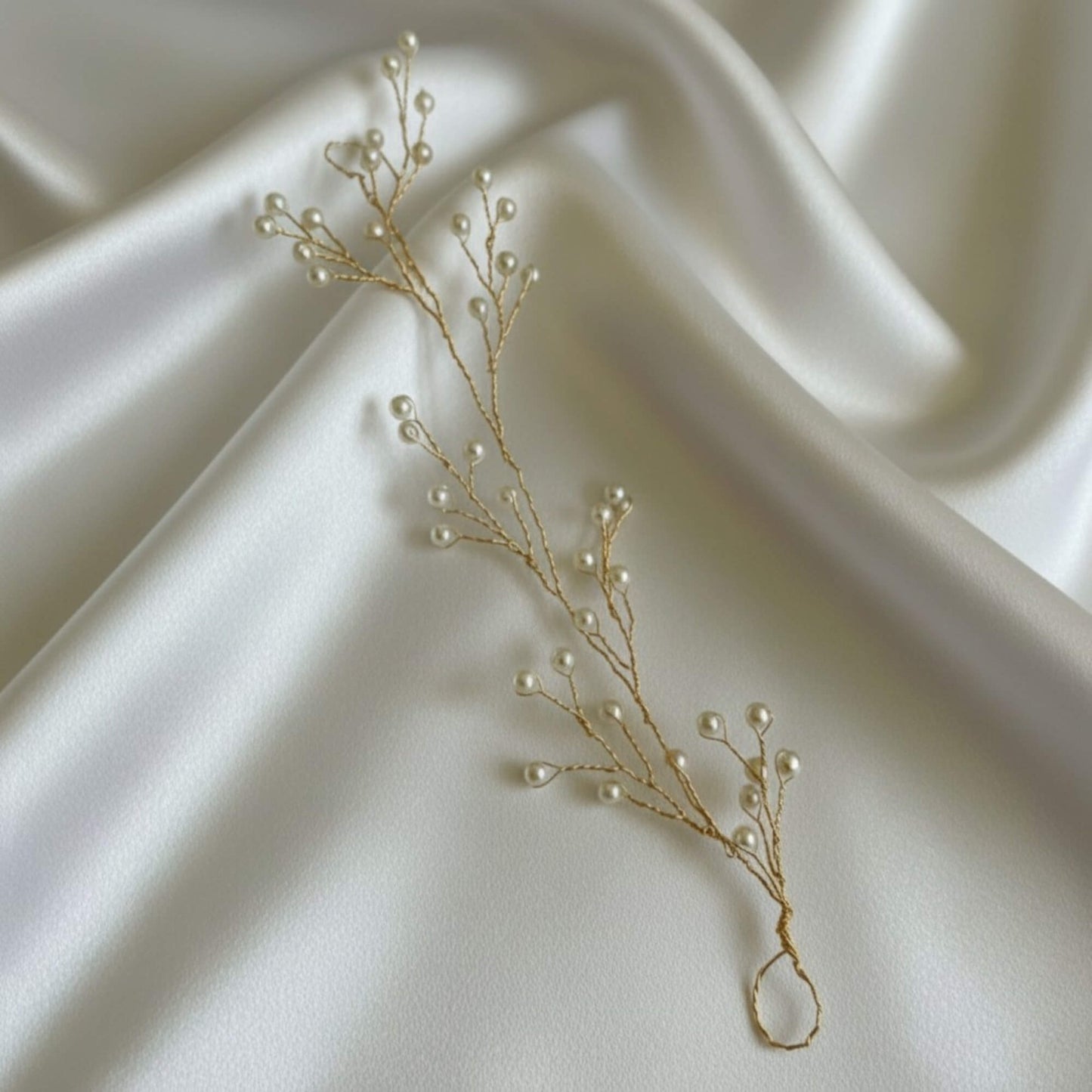 Lightweight pearl hair accessory on satin fabric