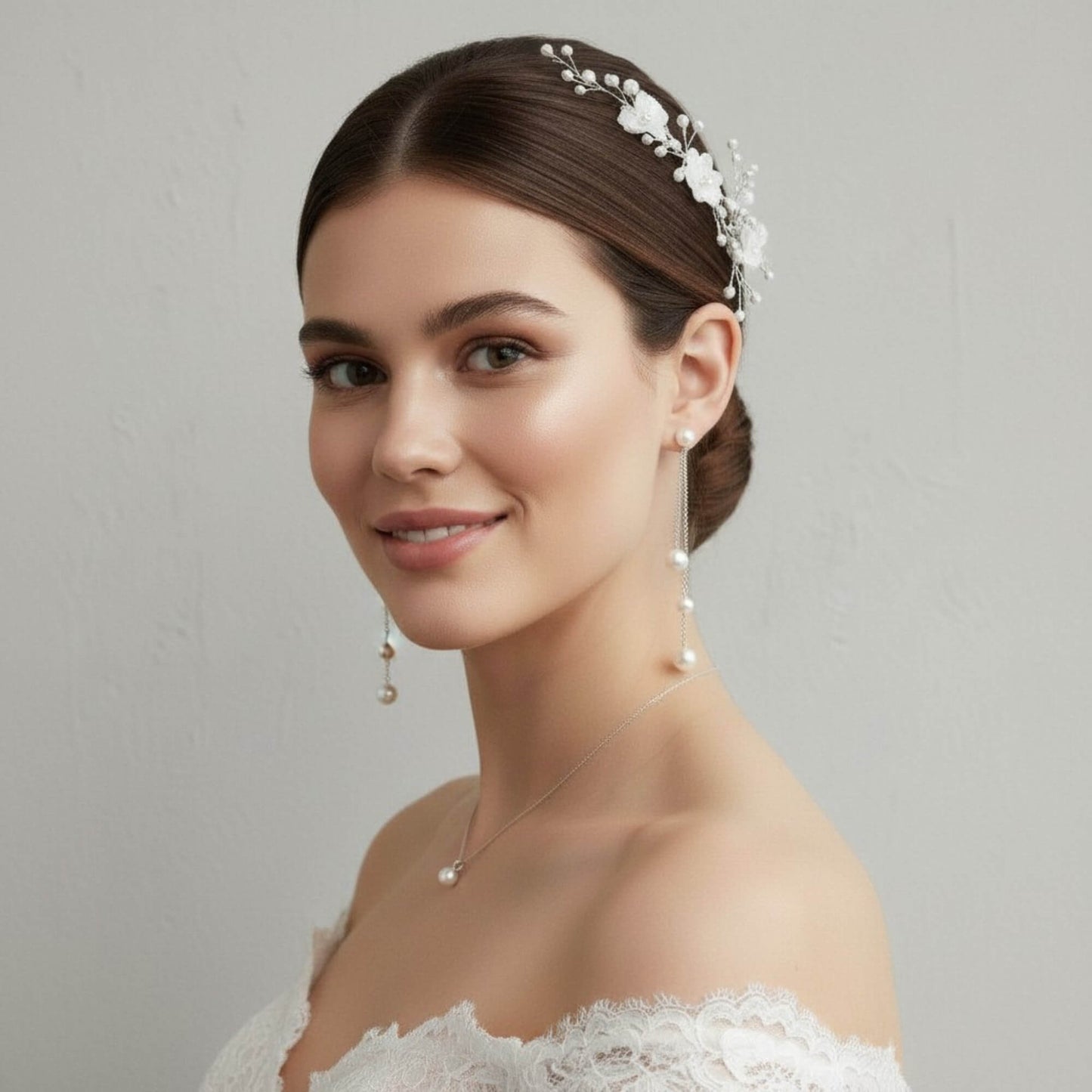 Close‑up bridal portrait showing delicate rose gold chain earrings with pearls