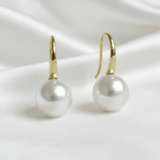 bridal Pearl earrings with gold hooks on a white satin background