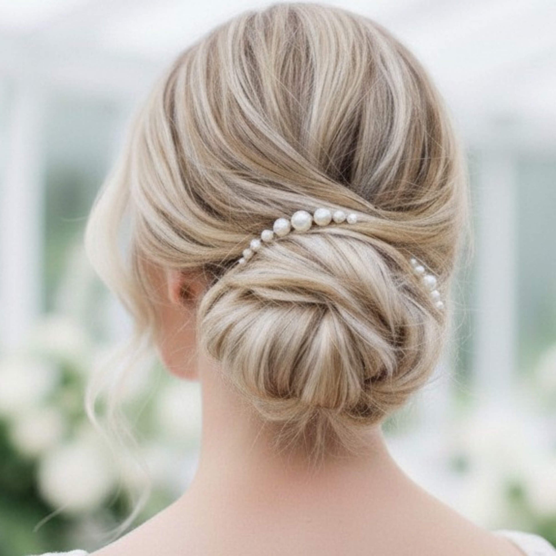 Bride styled in a textured updo featuring a silver pearl bridal hair pin.
