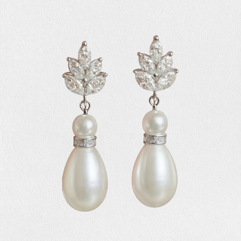 silver freshwater pearl drop earrings photographed on white textured background