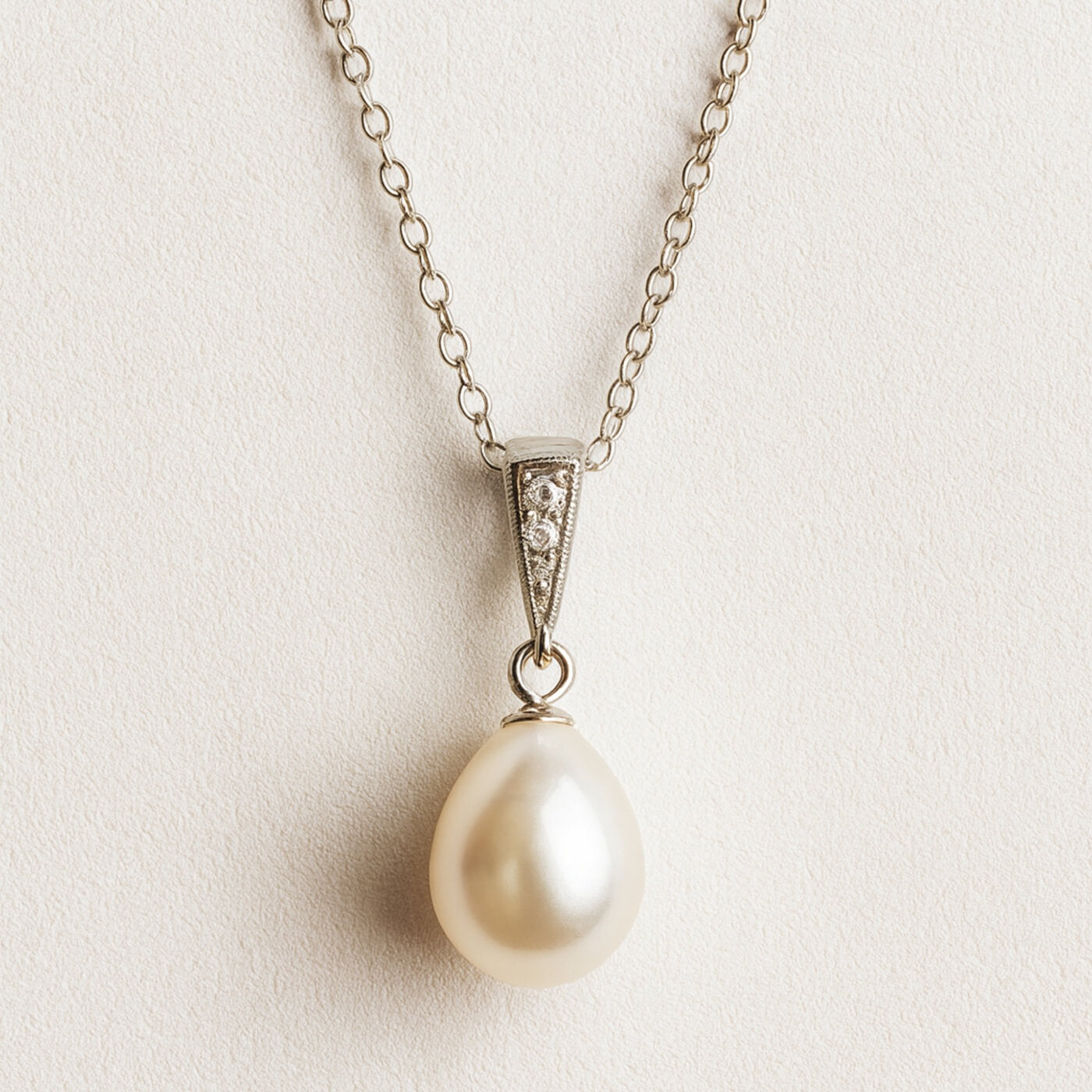 S925 sterling silver freshwater pearl earrings photographed on soft textured surface