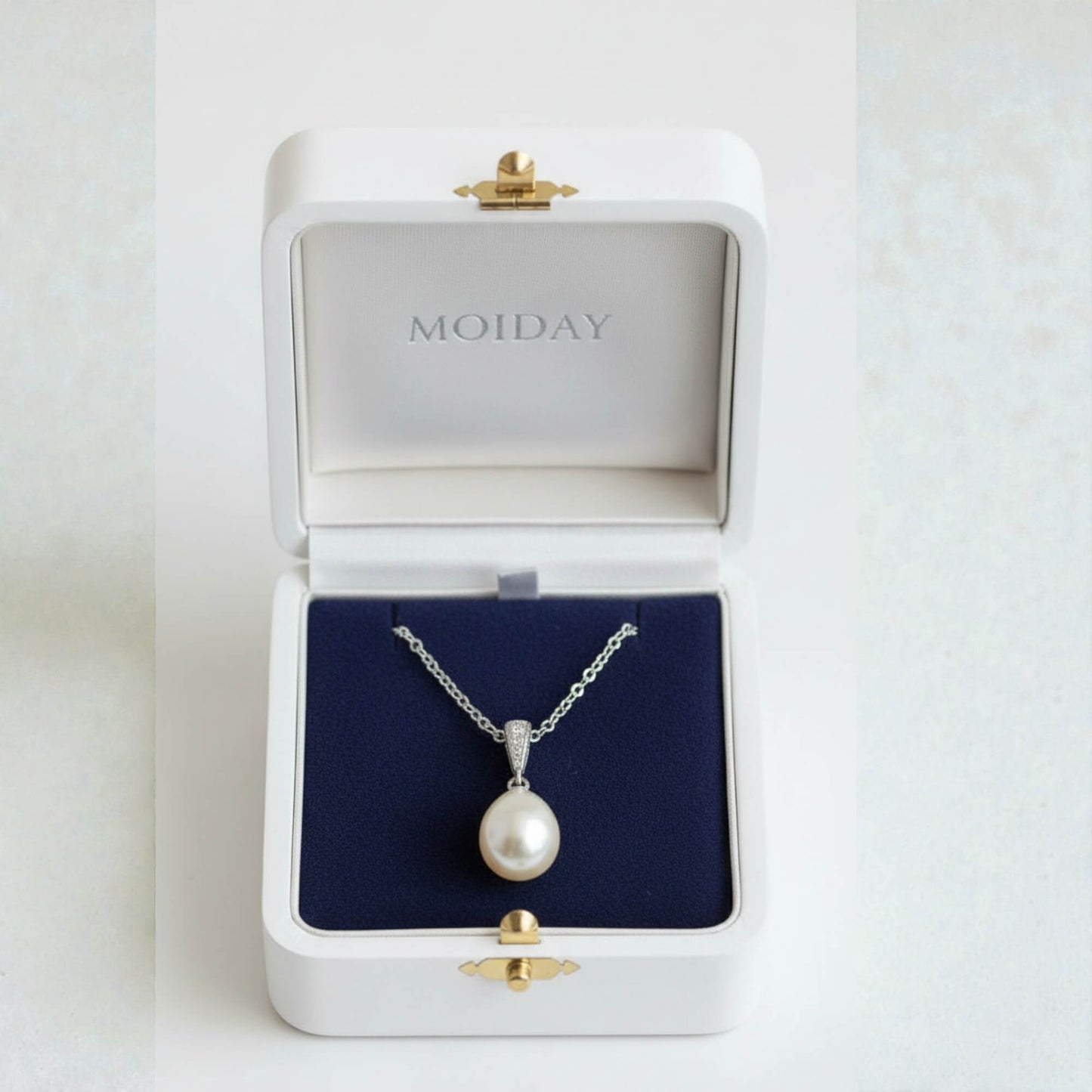 gold-plated freshwater pearl bridal necklace photographed on smooth neutral setting