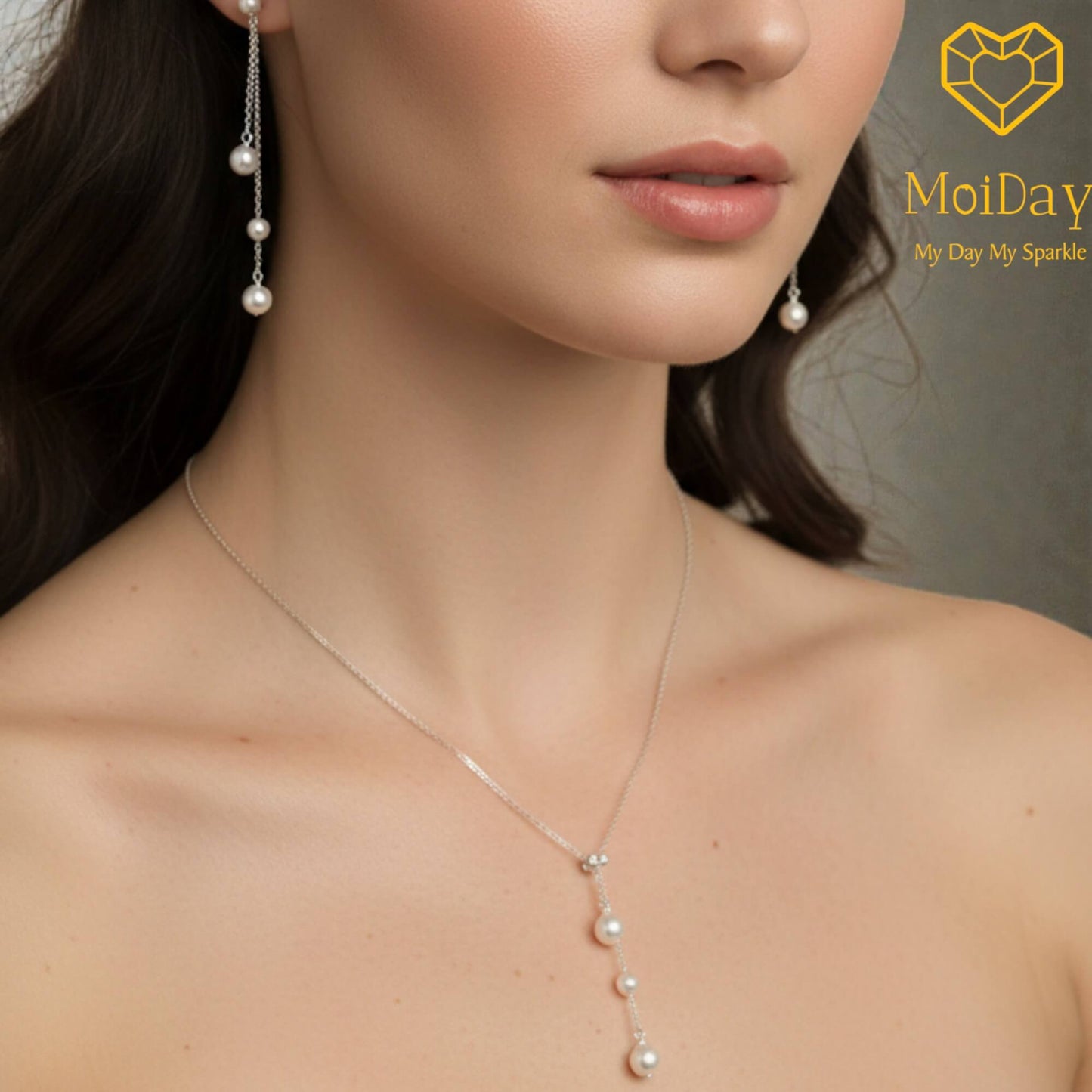 Pearl necklace and earrings on a model with MoiDay logo.