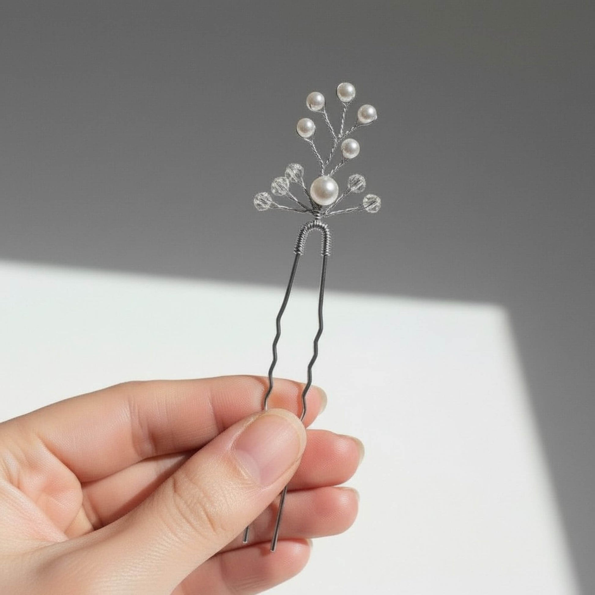 Set of gold bridal hair pins with organic pearl and crystal branch details photographed in natural light.