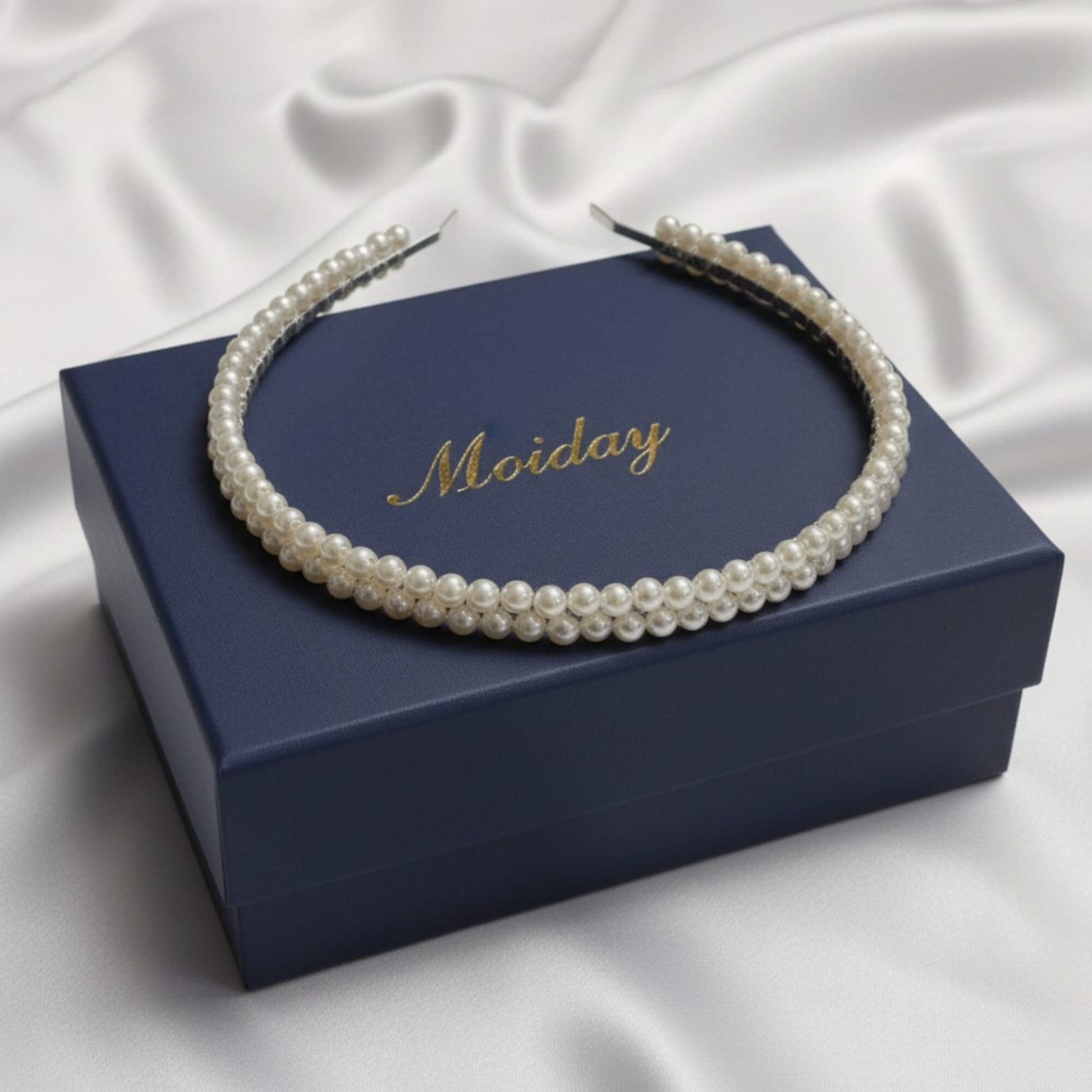 Close-up bridal portrait showcasing a soft‑white glass pearl headband on a silver base.