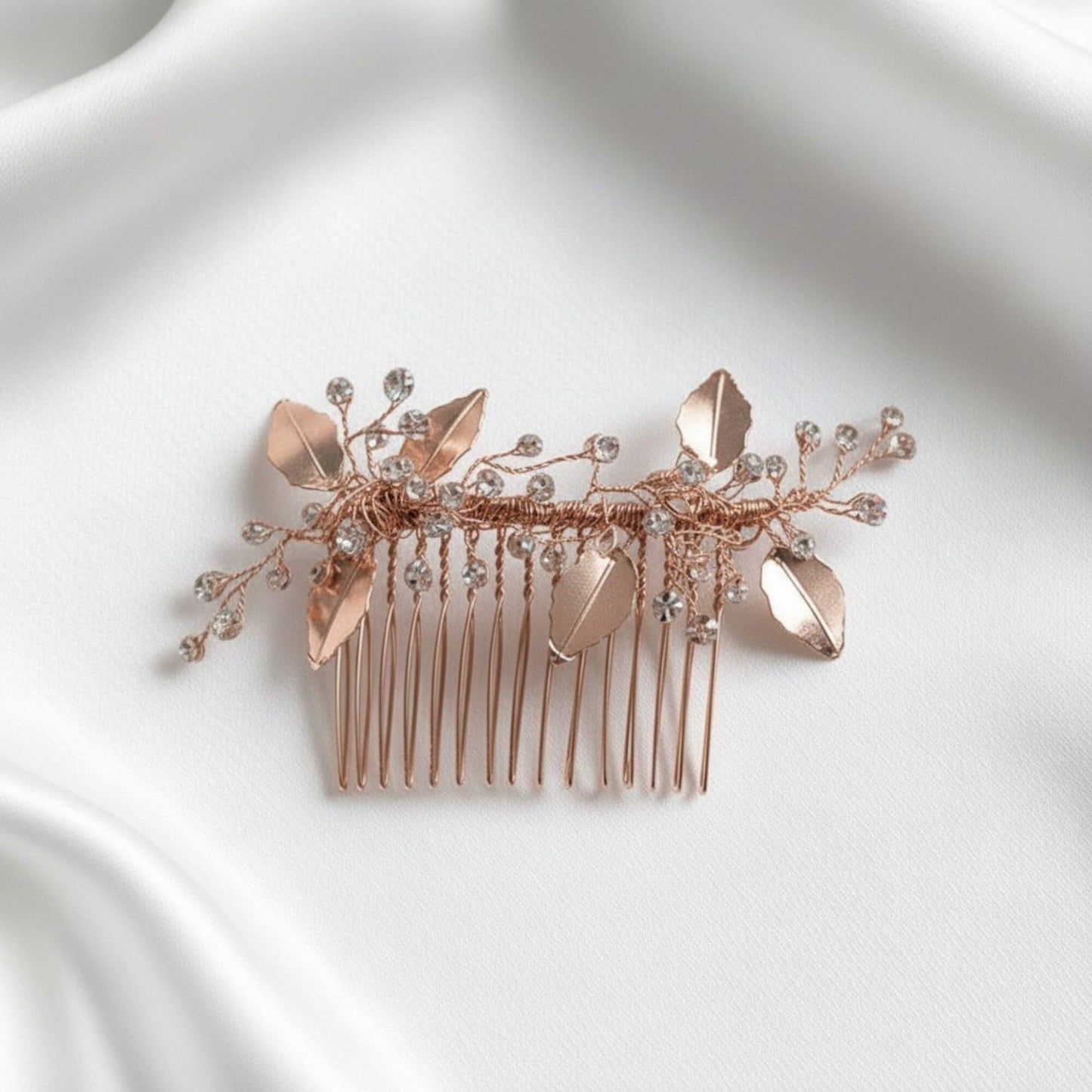 Silver botanical crystal bridal hairpiece on clean white surface