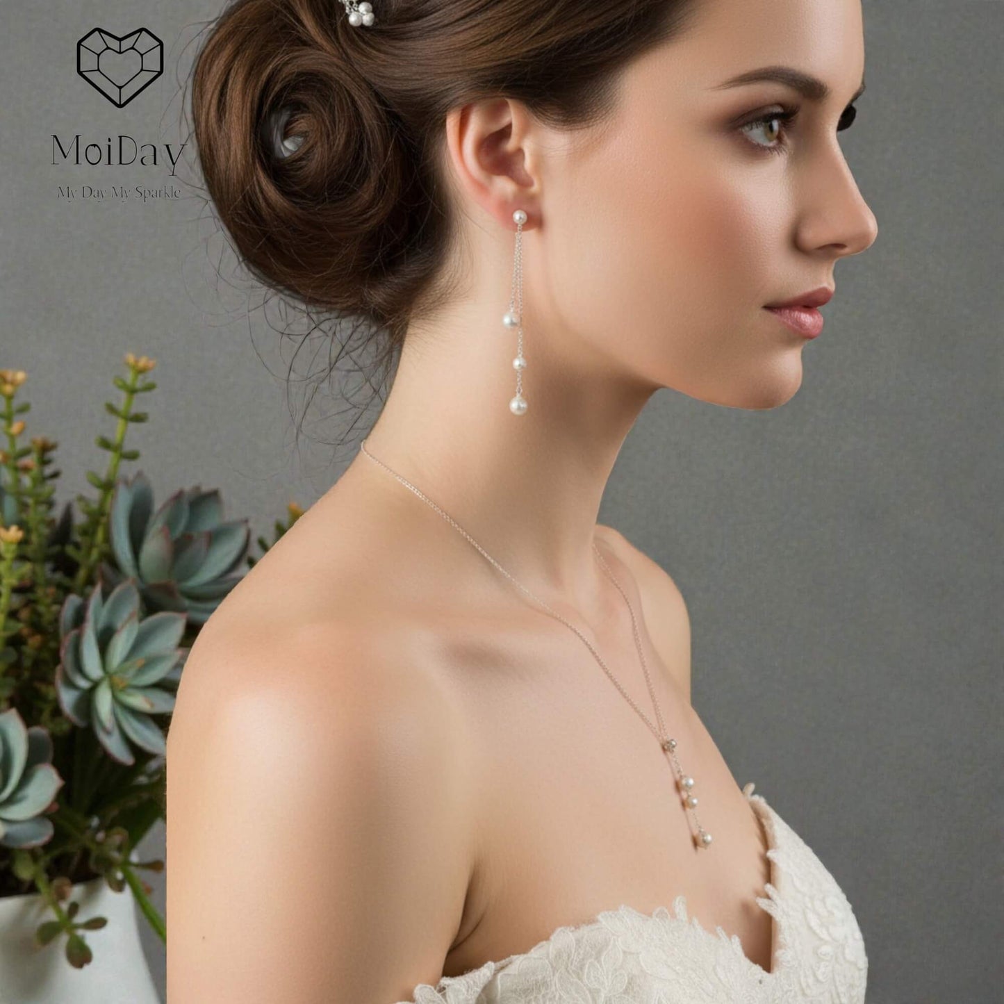 Woman wearing earrings and a necklace with a gray background and 'Moideay' logo.