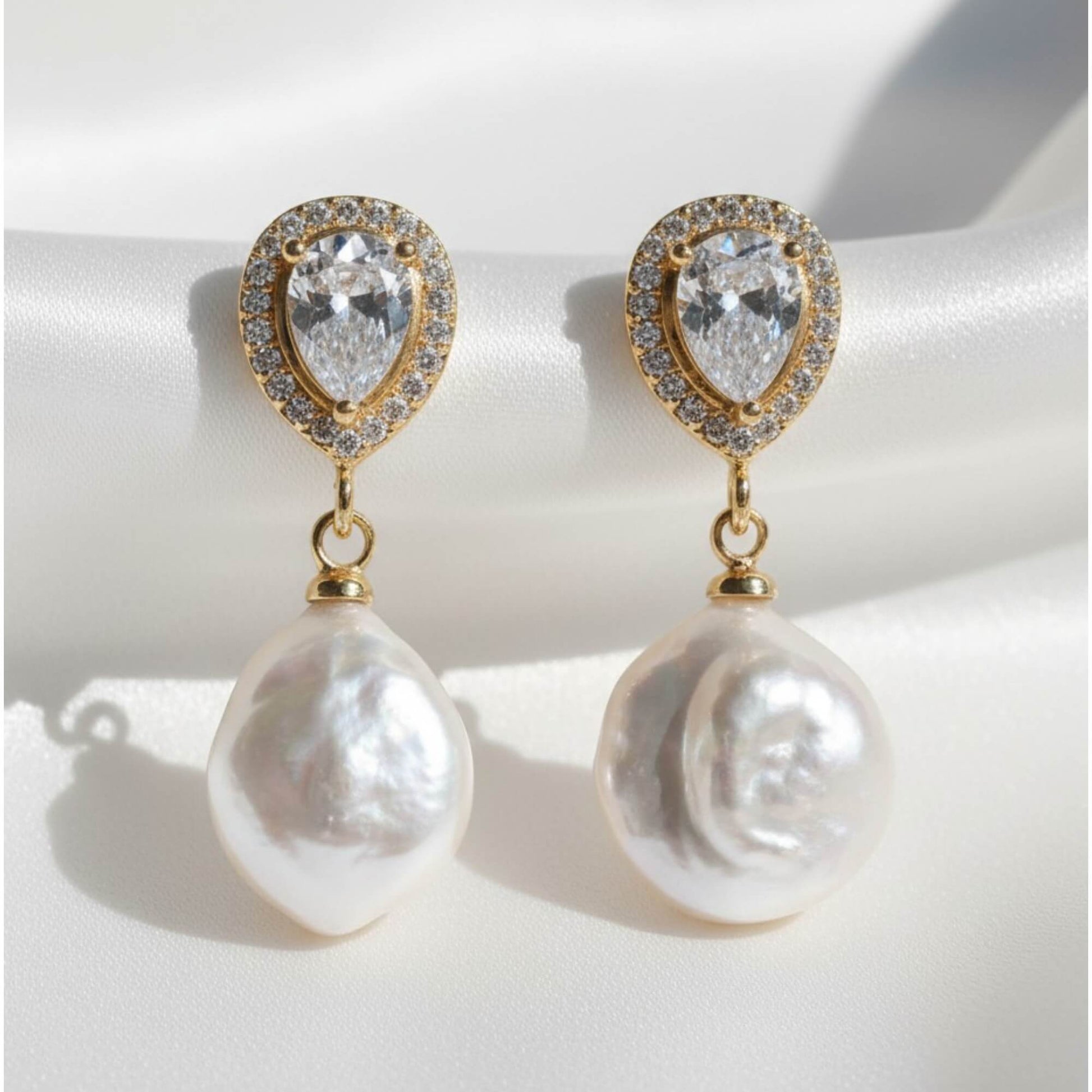 Pearl earrings with gold accents on a light background bridal jewellery australia