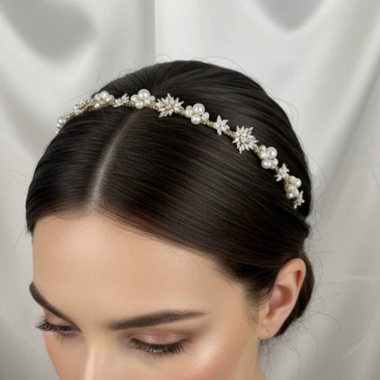 Bride wearing gold pearl and zircon headband with low textured bun