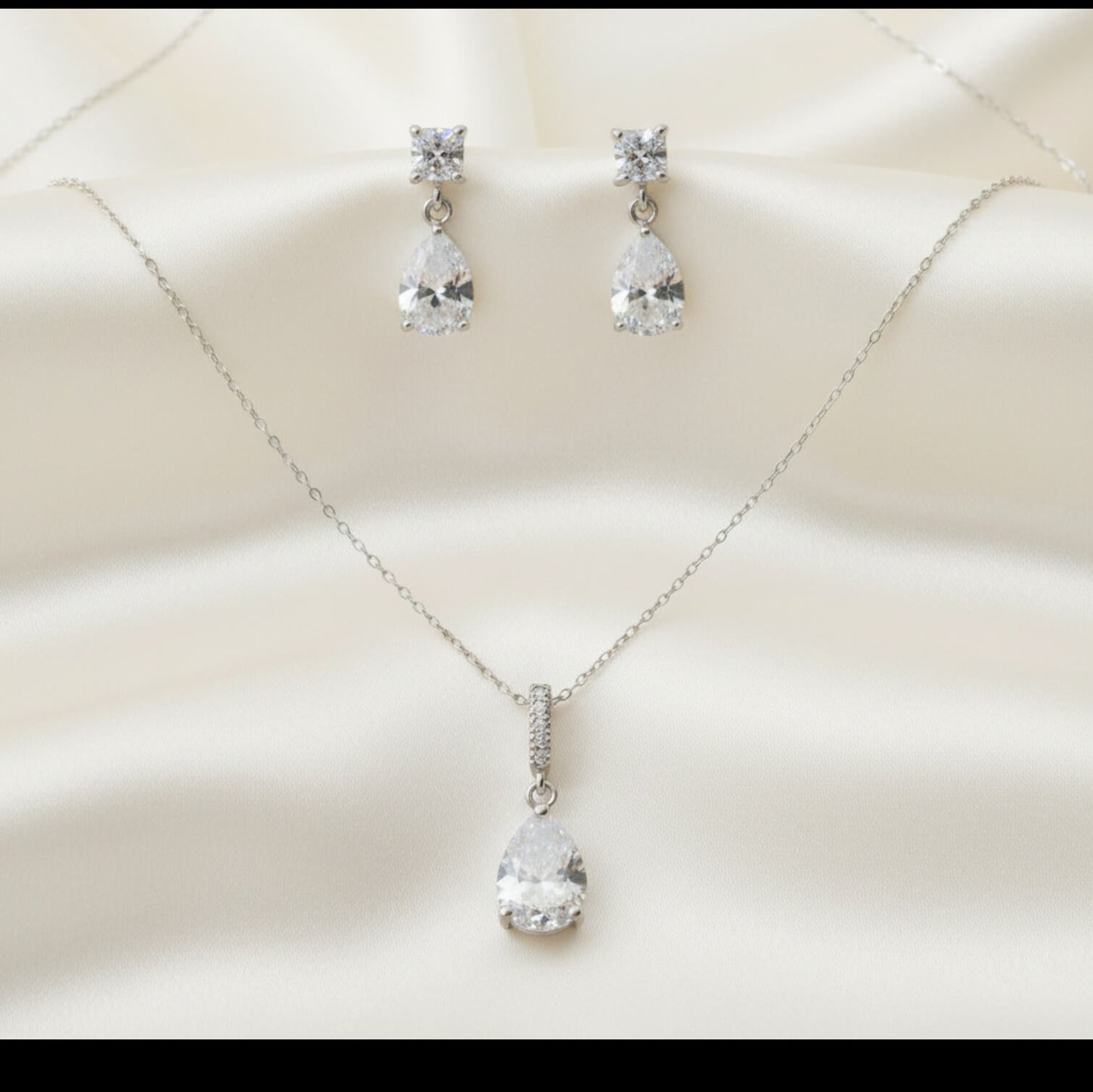 Jewelry set with necklace and earrings on a soft beige background