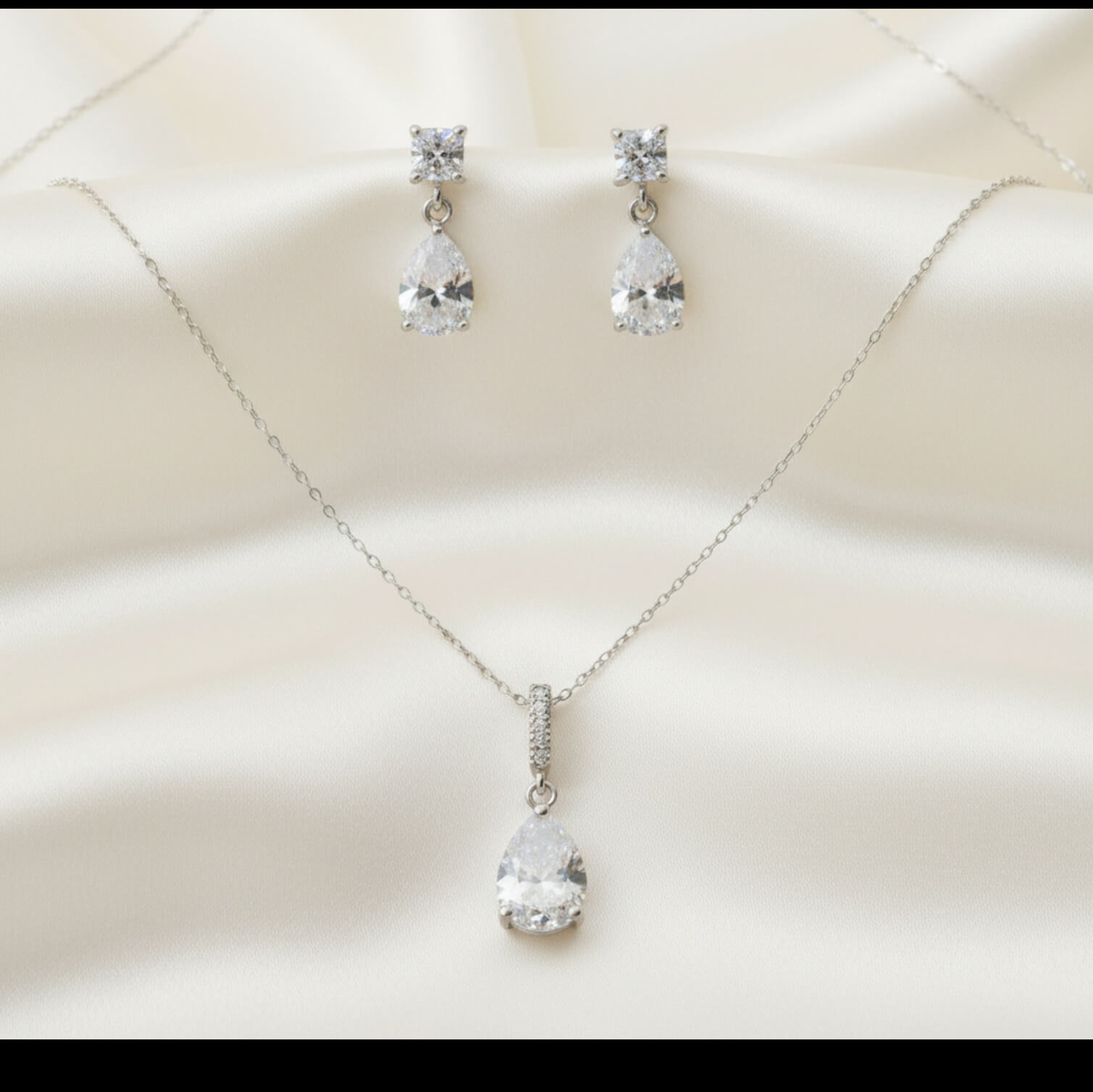 Jewelry set with necklace and earrings on a soft beige background