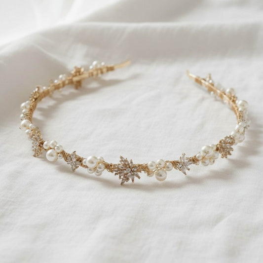 Gold bridal headband with pearl blossoms photographed in soft natural light