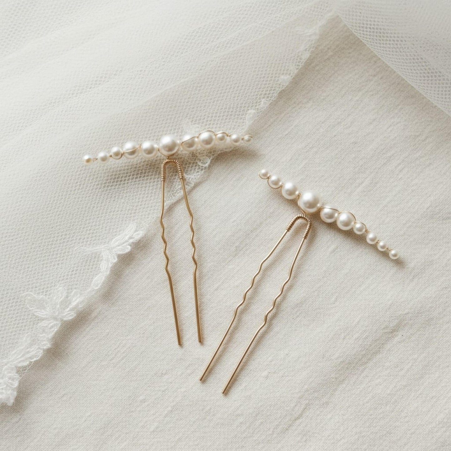 Close-up of gold bridal hair pin showing fine wire branches and pearl clusters.