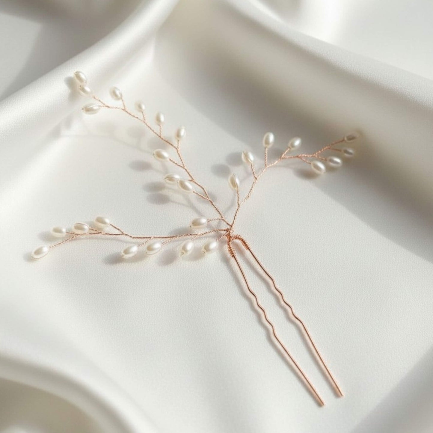 Close-up of rose gold bridal hair pin showing pearl clusters and fine wire craftsmanship.