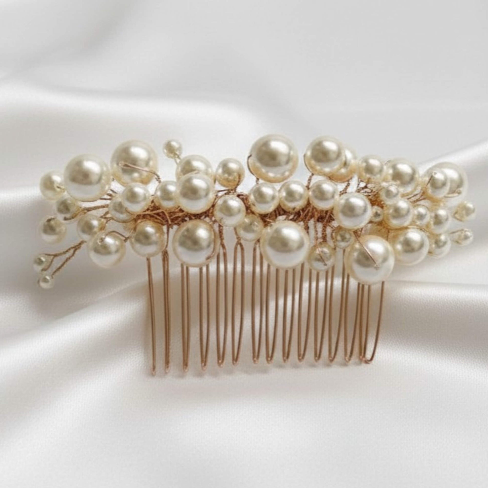 Pearl hair comb on a white fabric background
