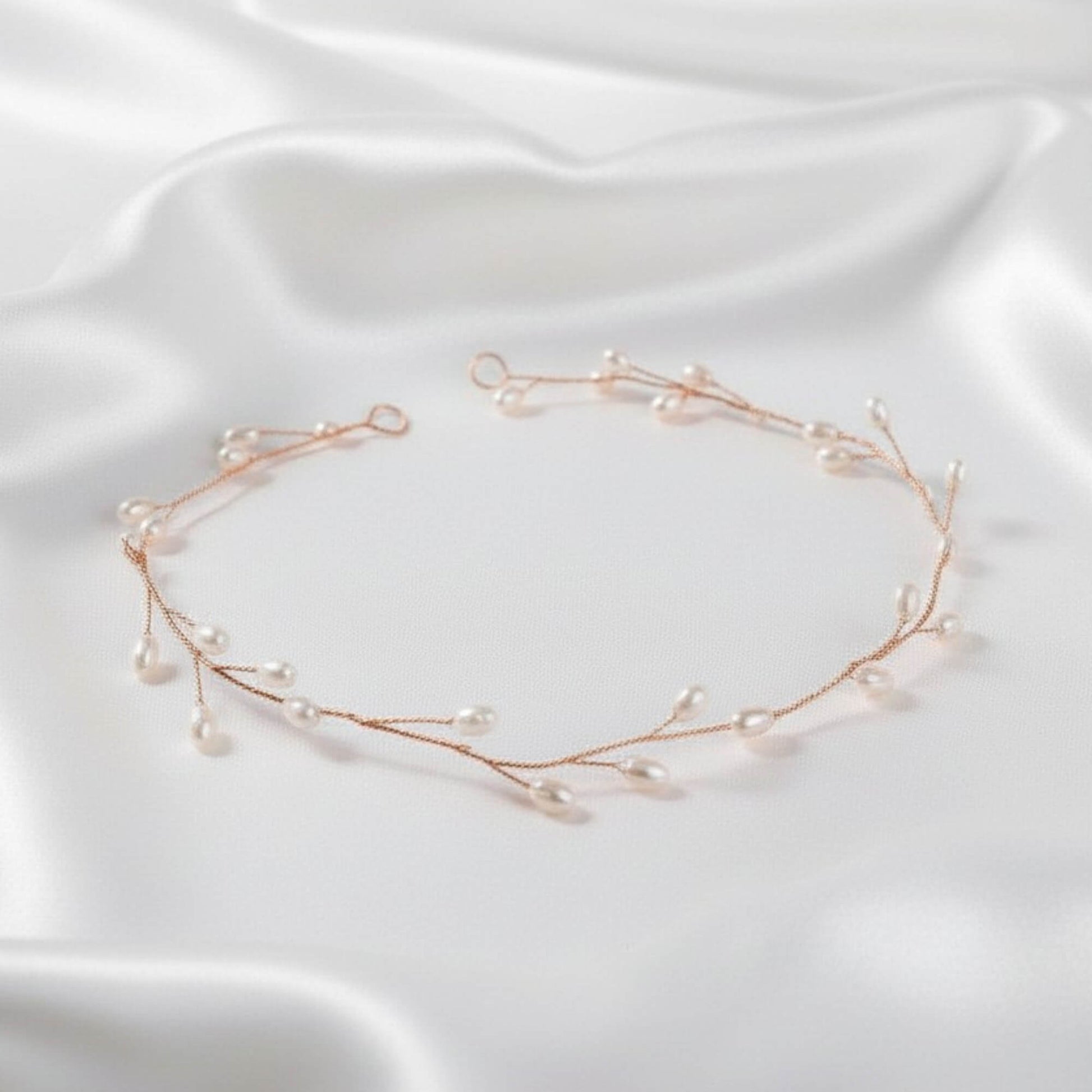 Rose gold bridal hair vine with pearls on soft bridal waves