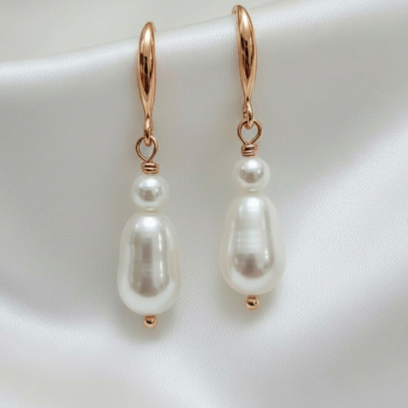S925 silver double‑drop earrings photographed on white satin fabric