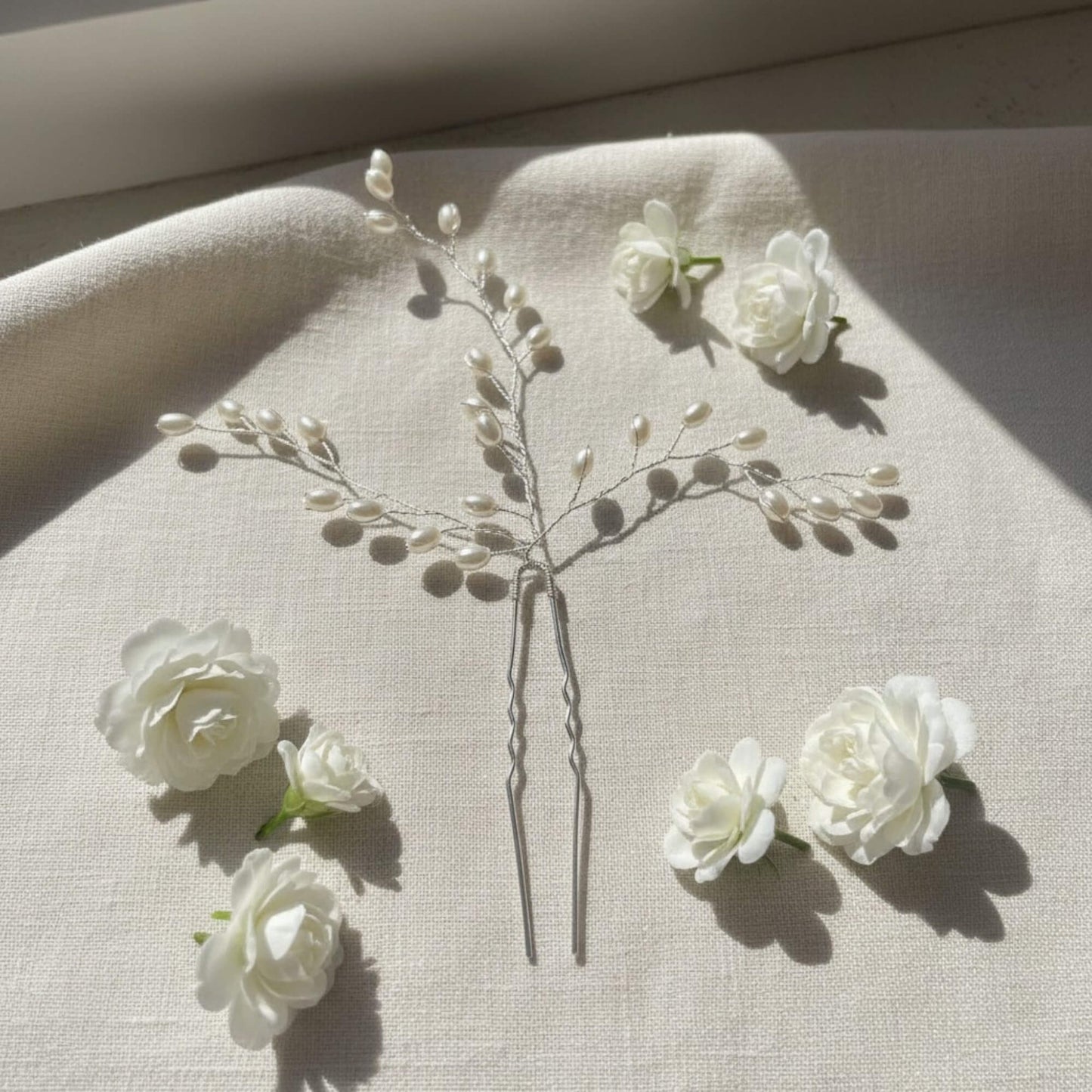 Close-up of rose gold bridal hair pin showing pearl clusters and fine wire craftsmanship.