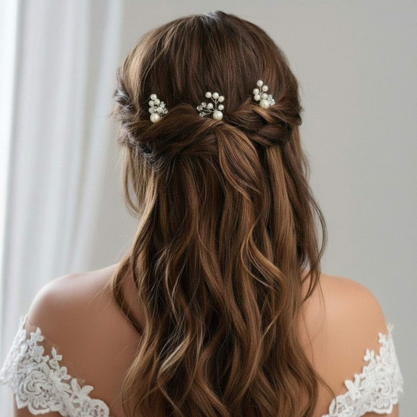 Bride with loose waves adorned with gold pearl hair pins placed along the side.