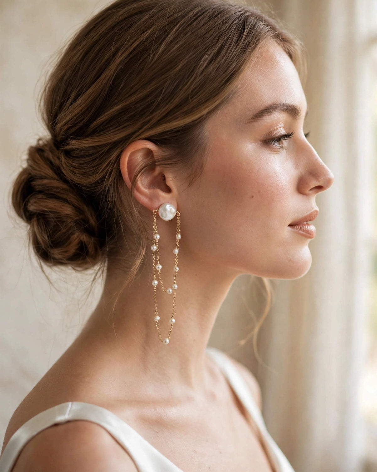 Bride wearing elegant freshwater pearl dangle earrings for her wedding