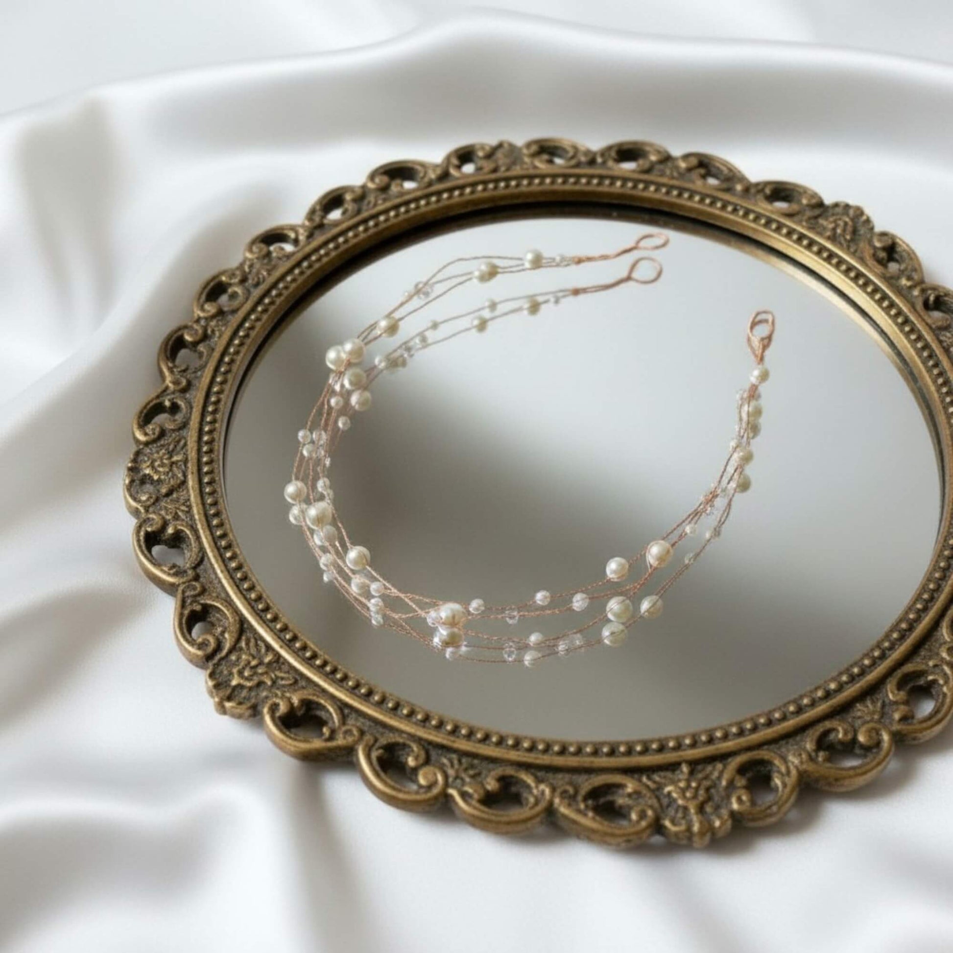 Bridal pearl hairvine laid flat showing its curved flexible design.

