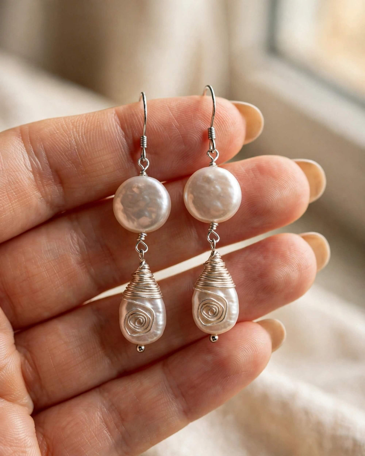 hanging view of pearl drop earrings highlighting teardrop pearl