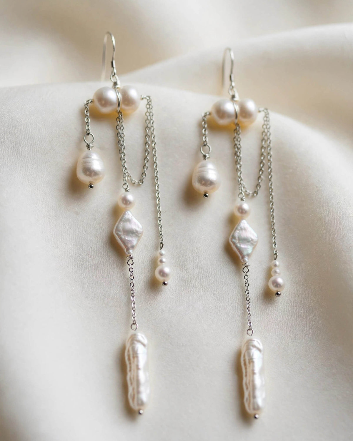 Front view of elegant pearl drop earrings