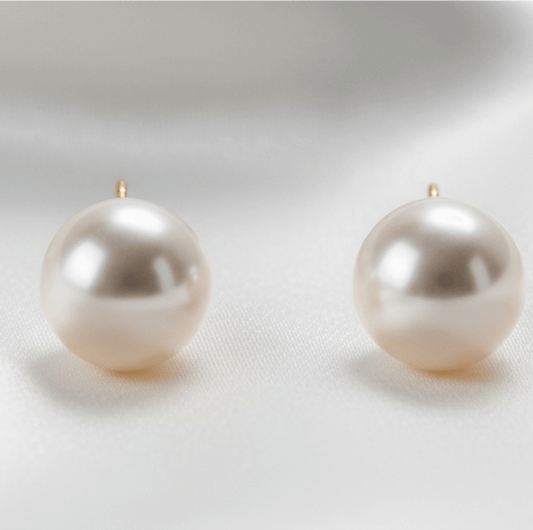 Pair of bridal pearl earrings on a light gray background