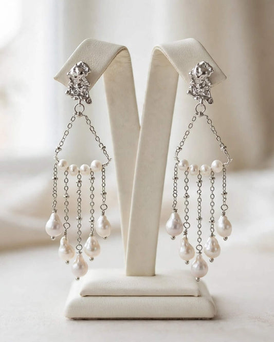 Bride wearing freshwater pearl dangle earrings with an elegant wedding look