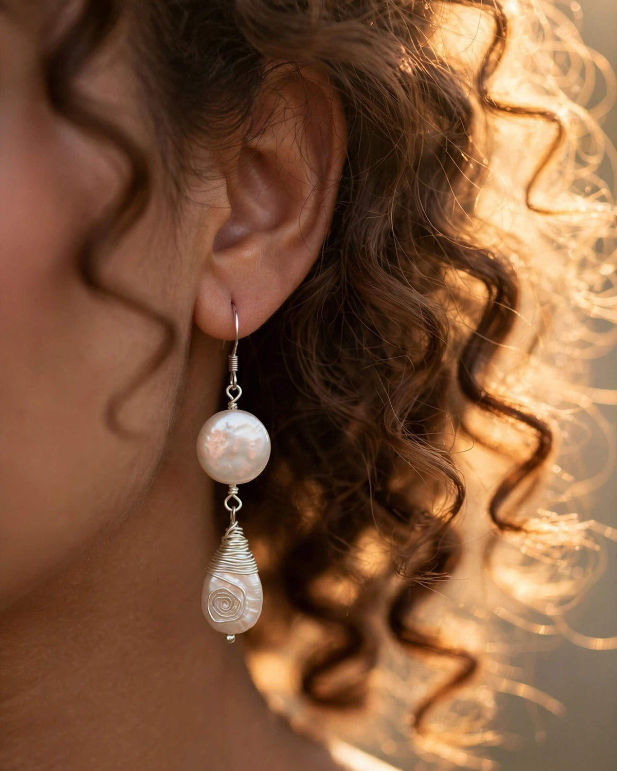 bride with pearl drop earrings styled with soft bridal waves