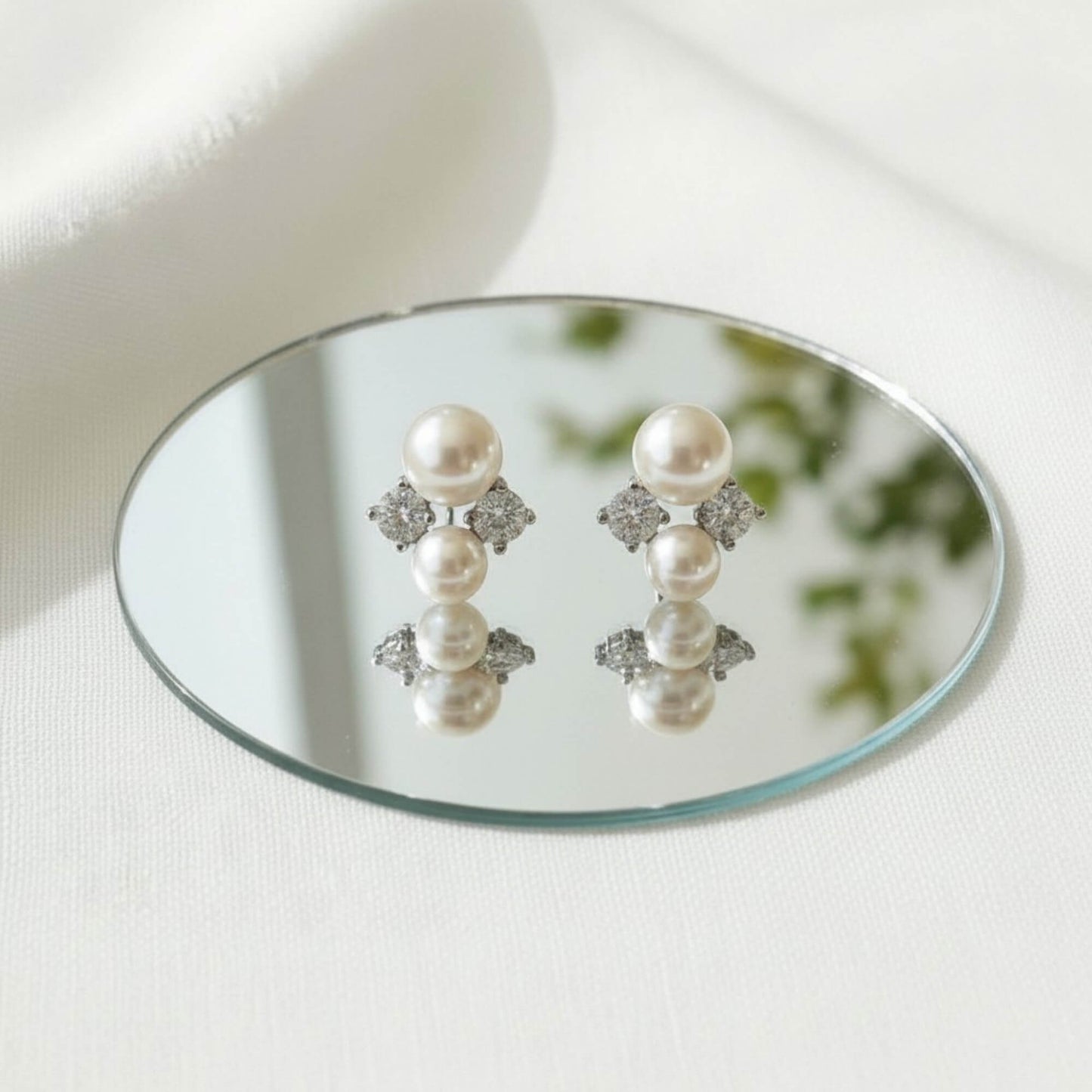 Freshwater pearl and zirconia earrings displayed on a clean minimal background, 925 silver setting.
