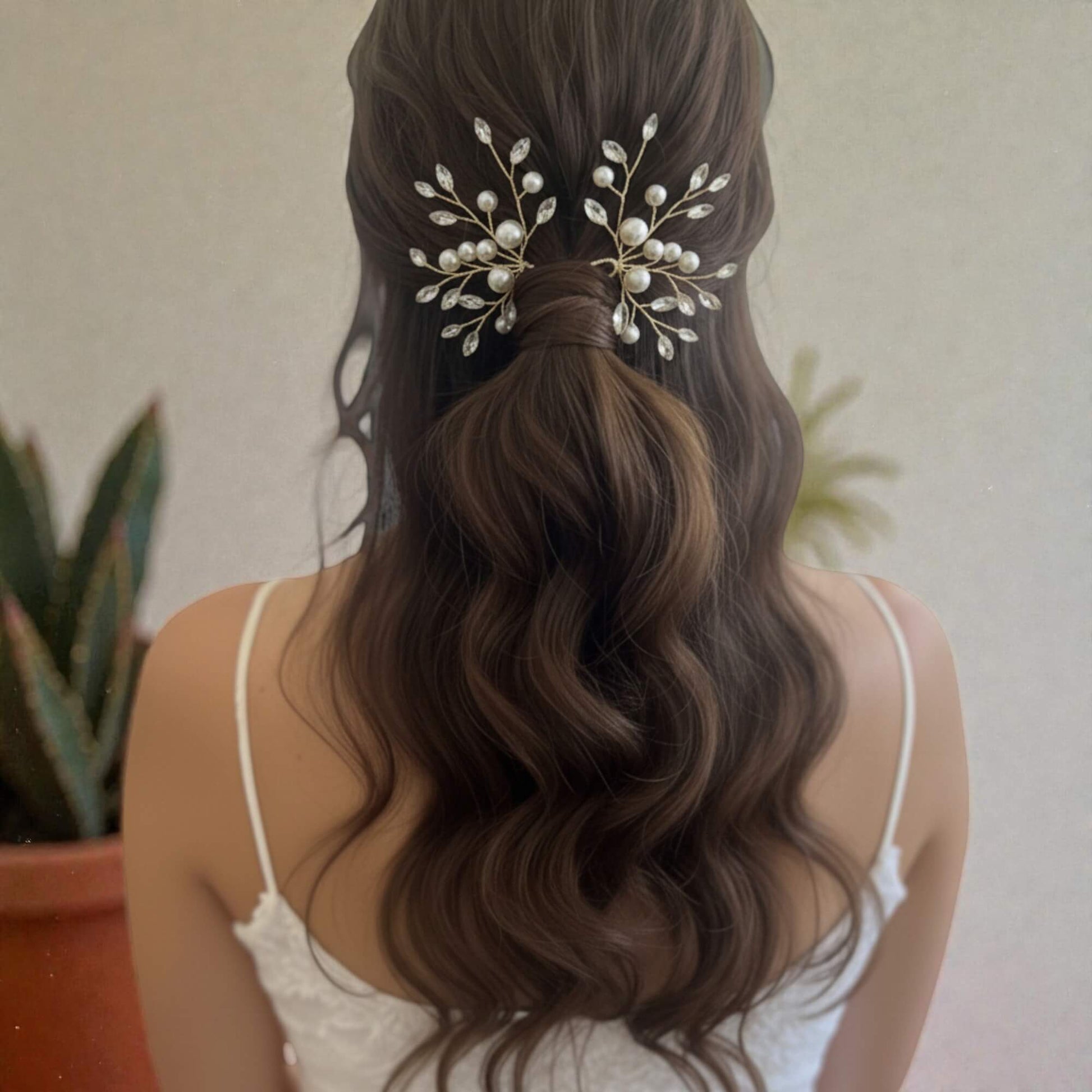 Delicate pearl bridal hairpiece with crystal accents, photographed on white satin fabric.