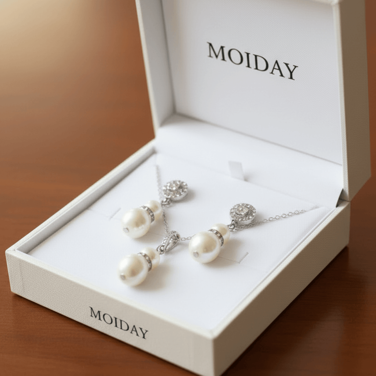 Pearl earrings in a 'MOIDAY' branded box on a wooden surface