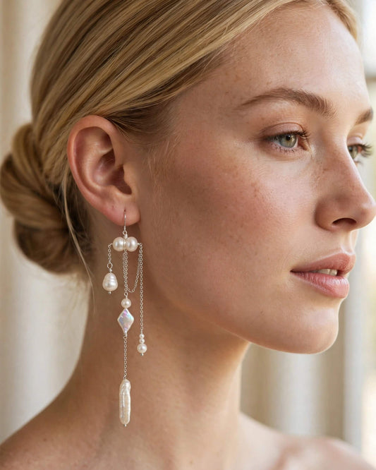 Bride wearing freshwater pearl drop earrings at a wedding