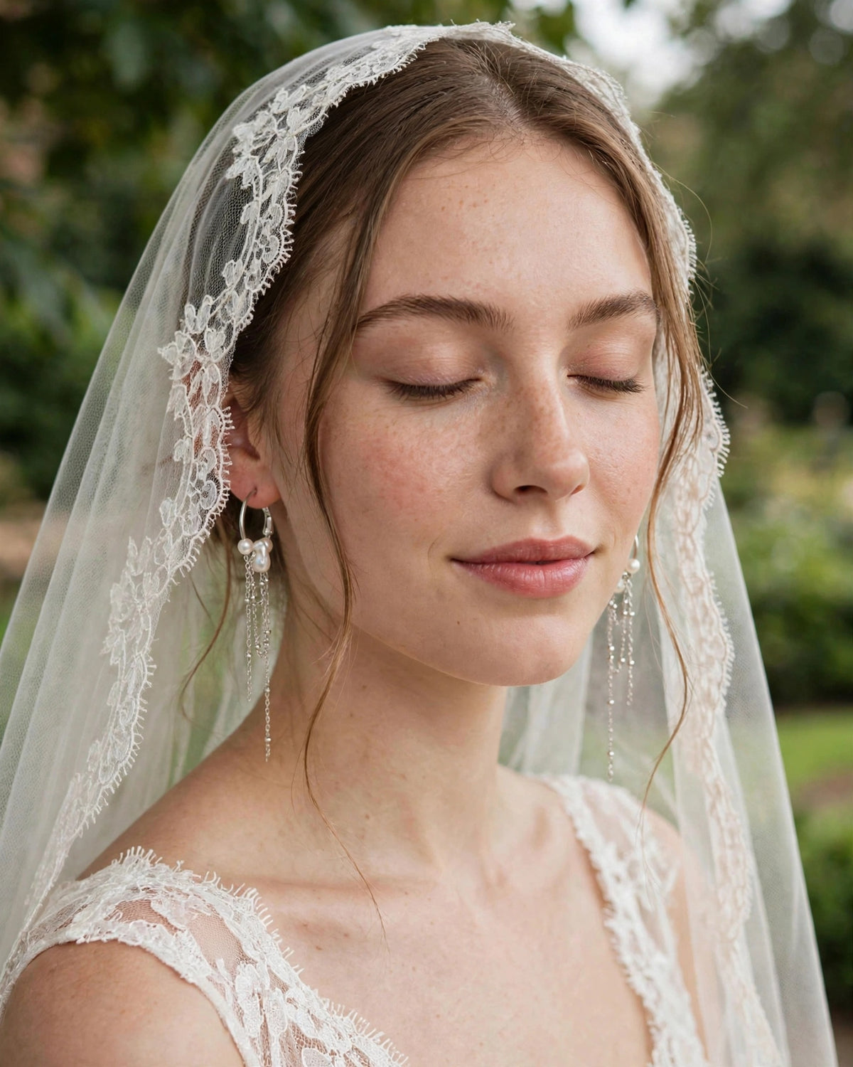  Bride wearing elegant freshwater pearl earrings with a graceful drop design