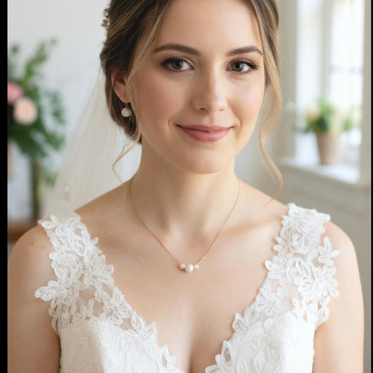 Woman wearing a white lace wedding dress with a veil indoors.