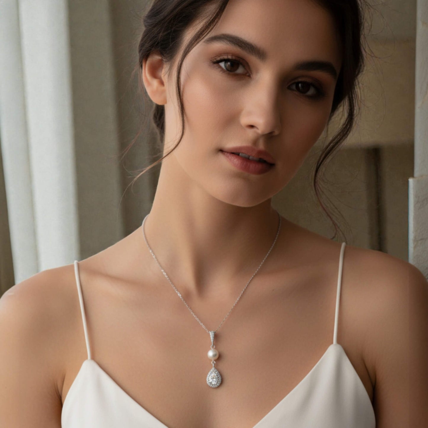 Minimal silver chain necklace featuring freshwater pearl and teardrop crystal