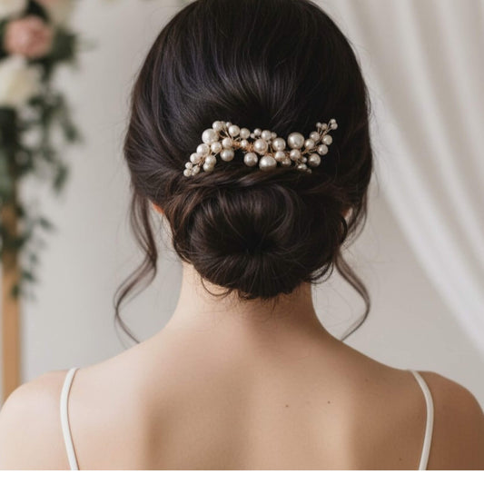 Gold pearl bridal hairpiece styled in an elegant low bun.