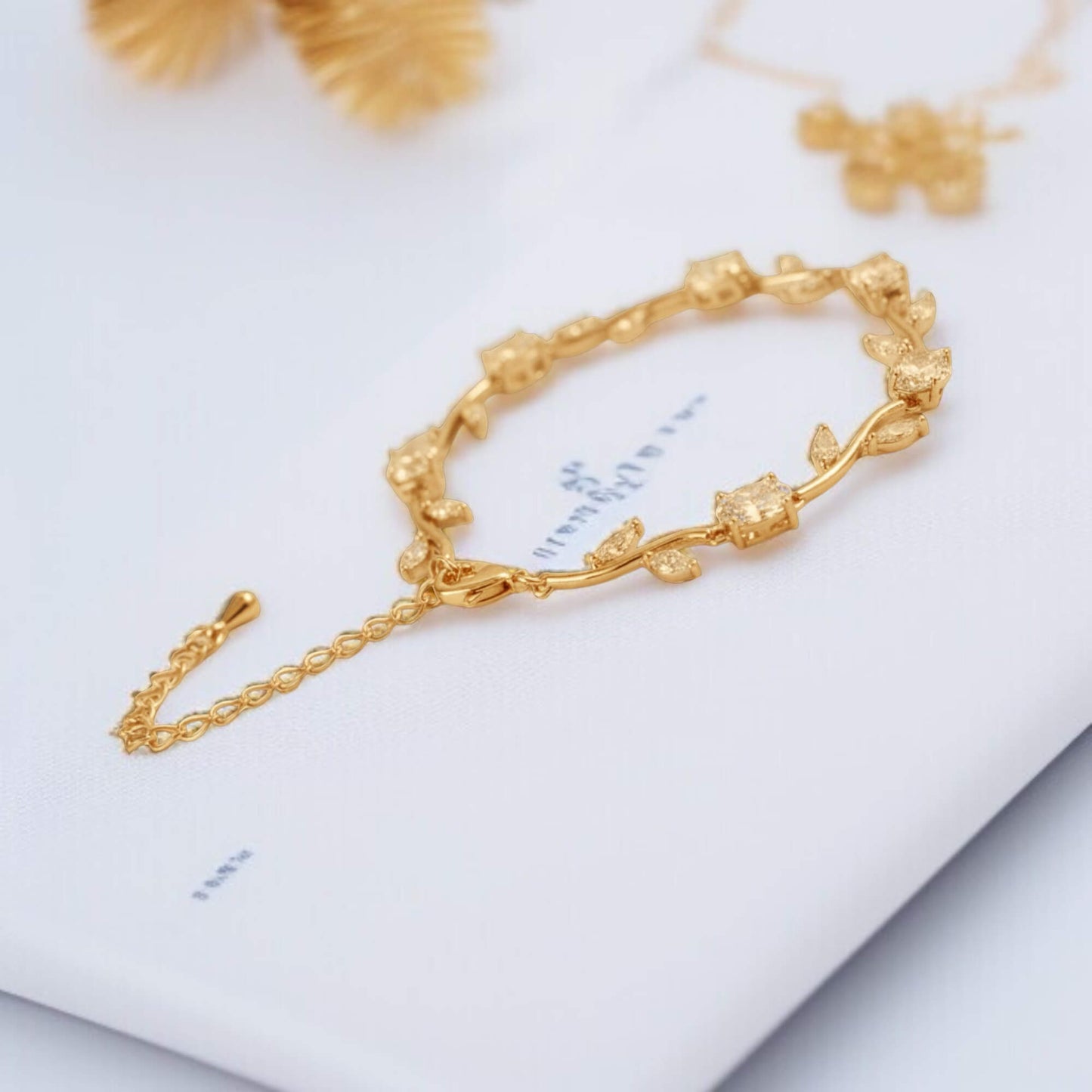 Moiday Celeste Vine Bridal Bracelet in silver with leaf motifs and sparkling stones on marble background.