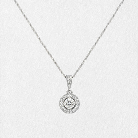 Gold bridal necklace with halo pendant displayed on white textured background, highlighting diamond details