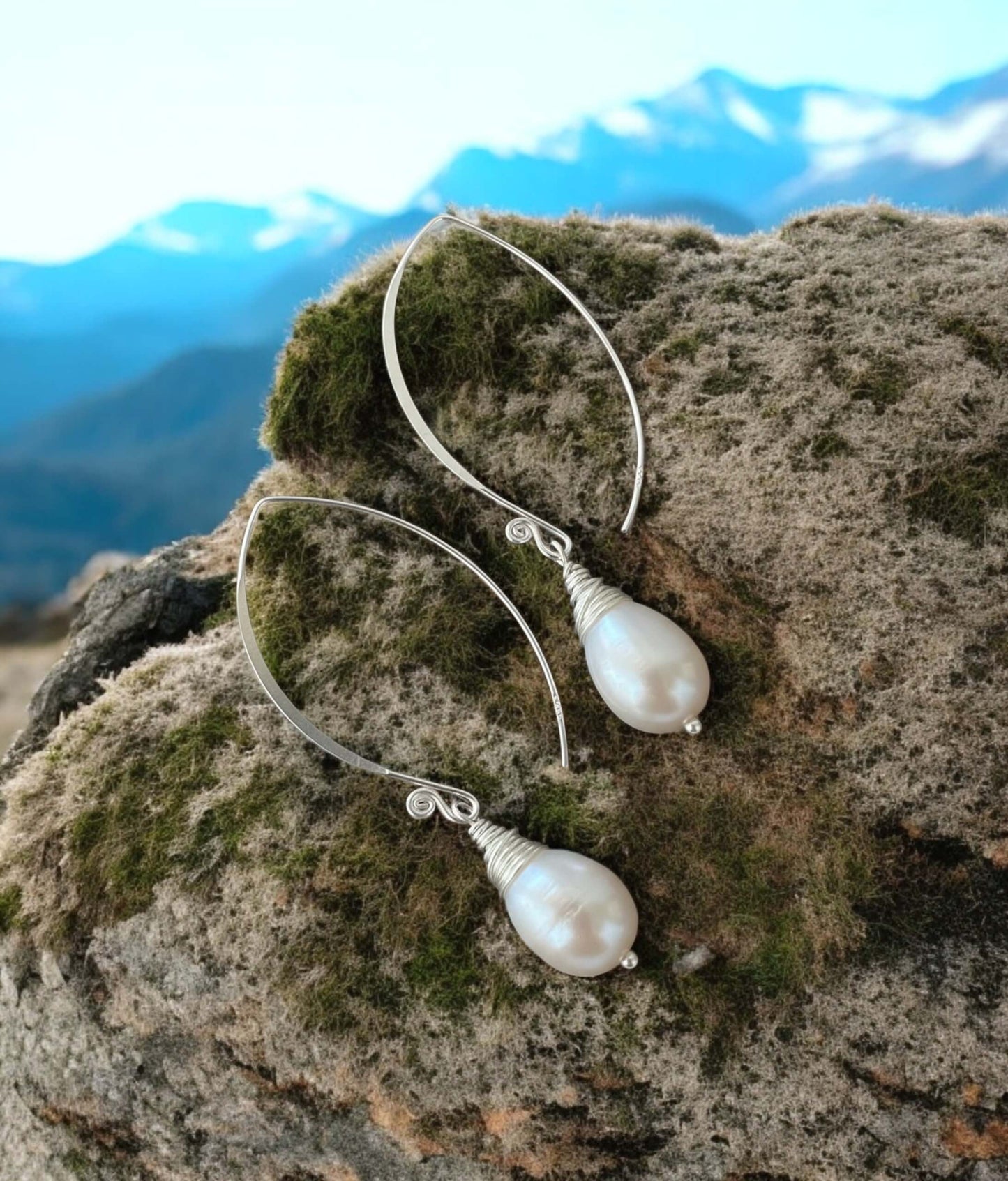 sterling silver S925 pearl drop earrings photographed on mountain