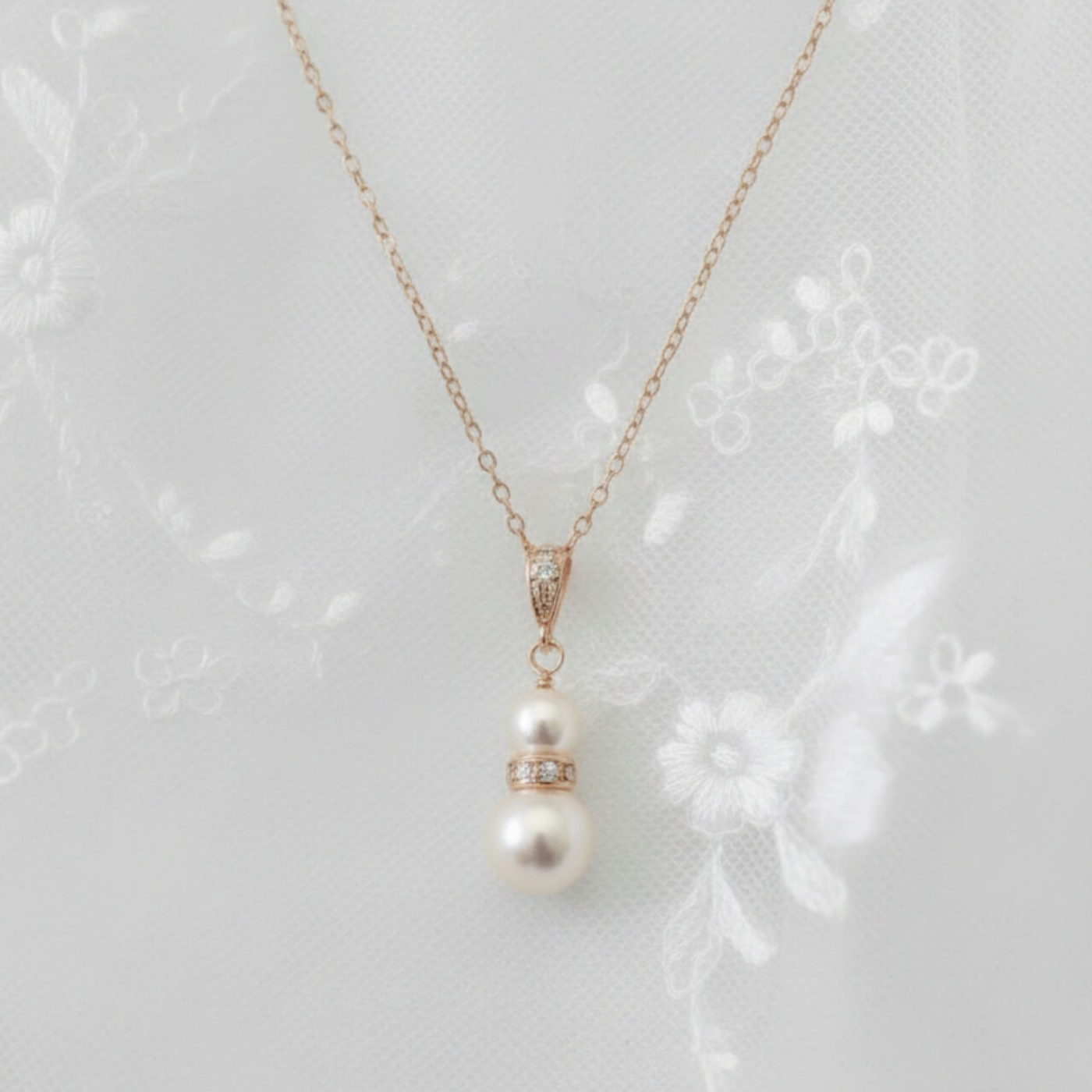 Rose gold and pearl pendant necklace photographed worn with lace bridal dress