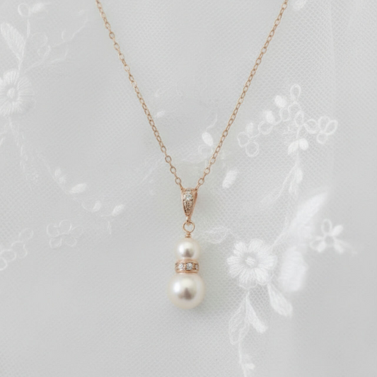 Rose gold and pearl pendant necklace photographed worn with lace bridal dress