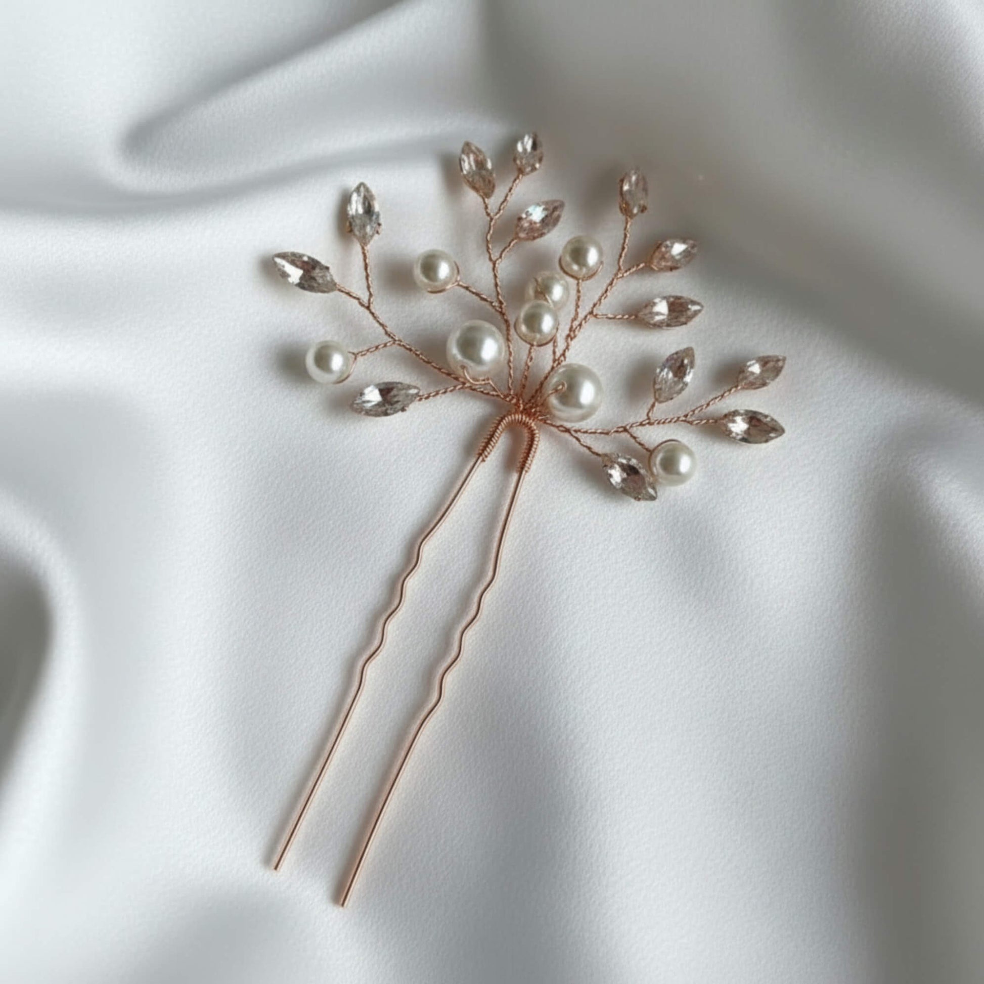 Close‑up of rose gold pearl bridal hair pin featuring premium glass pearls and crystal leaves.